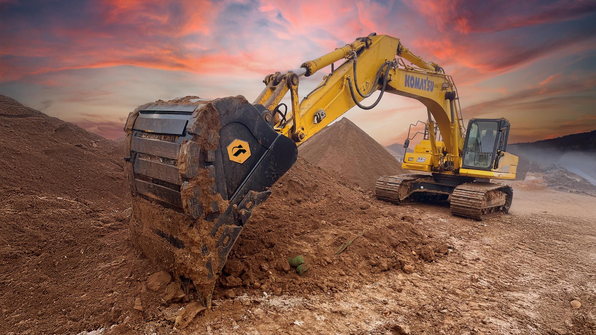 A large excavator digging dirt with a heavy duty bucket.